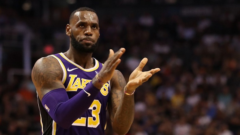 Lakers star LeBron James claps during a game against the Timberwolves.
